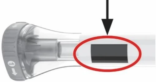 Detail of a medical device with a black arrow pointing to a dark rectangle highlighted by a red circle on a transparent tube