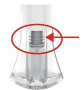 Detail of a transparent medical device with a red arrow indicating an internal cylindrical section highlighted by a red circle