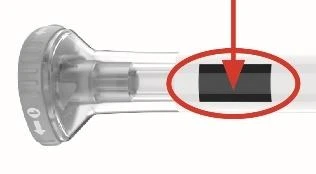 Detail of a transparent medical device with a red arrow pointing to a black rectangle at the