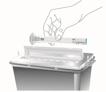 A hand holding an injection pen horizontally above a biological hazard medical waste disposal container