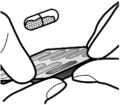 Two hands holding and opening a blister strip containing a capsule suspended above the medication surface