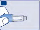 A hand holds a blue and white cylindrical medical device horizontally against a light blue background