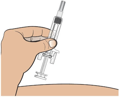 A hand holding a transparent syringe vertically with the needle pointing upward