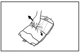 A hand pressing down and bending a rectangular medical device downward in the direction indicated by black arrows