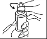 A hand holds a cylindrical vial while the