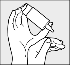 Two hands hold a tilted medicine bottle to release a drop from the dropper downward