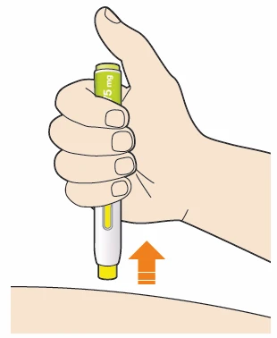 A hand gripping a white and yellow autoinjector pressed vertically against the skin of a thigh with an orange arrow pointing towards the