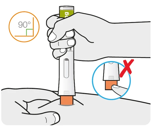 A hand gripping a white medical device for the
