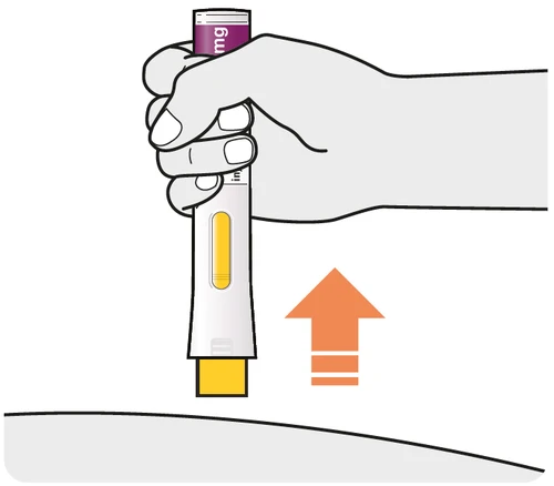A hand holding a white and yellow medical device oriented towards the
