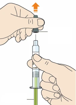 Two hands separating a gray cap from the body of a transparent syringe containing green liquid with an orange arrow pointing to the