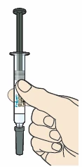A hand holding a transparent syringe vertically with liquid inside