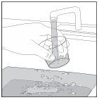 A hand holds a glass under an open tap to collect water