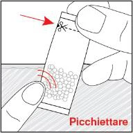 A hand holding a bag of powder and with