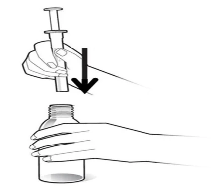 Two hands holding a syringe ready for use