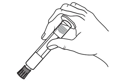 Two hands holding a cylindrical medical device with a grooved base and a transparent body angled downward