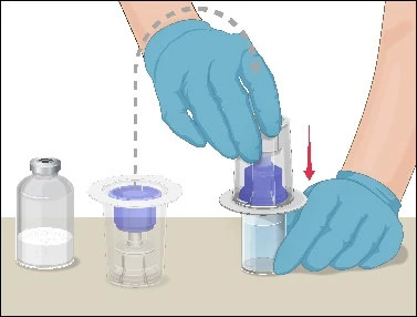 Hands wearing blue gloves pressing a transparent container down onto a glass vial to mix the contents, indicated by a red arrow