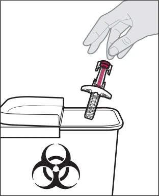A hand inserts a medical device containing pink liquid into a biological waste container marked with the biohazard symbol