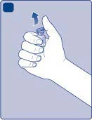 A hand holding a small glass vial upward