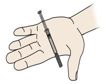 An open hand with fingers extended holding a syringe with needle and plunger positioned diagonally on the palm
