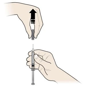 A hand lifting the gray cap off a syringe upward