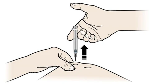 A hand holding a syringe vertically while another...