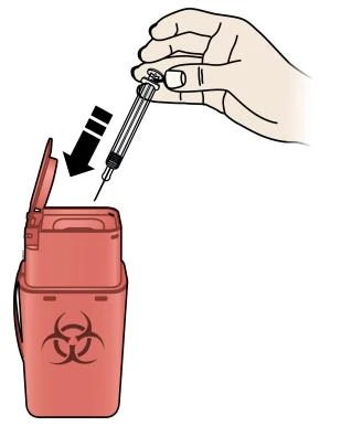 A hand holding a syringe and inserting it into a red biological waste container marked with the biohazard symbol