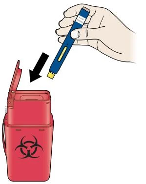 A hand holding a blue and yellow injection pen inserting it into a red biological waste container with biohazard symbol