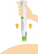 A hand holding a white medical device with green details and orange arrows pointing toward the