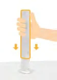 A hand holding a cylindrical white medical device with orange arrows indicating downward pressing movement