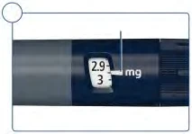 Close-up of a medical device with a display indicating a dose of 2.9 mg on a dark background with white numerical scale