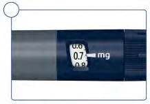 Detail of a blue medical device with a display showing a dose of 0.7 mg between the values 0.6 and 0.8 mg