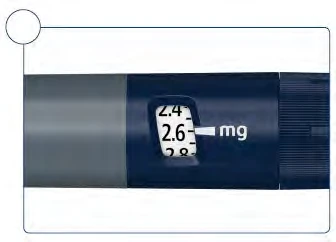 Detail of a medical device with a display showing a dosage of 2.6 mg between the values 2.4 and 2.8 mg