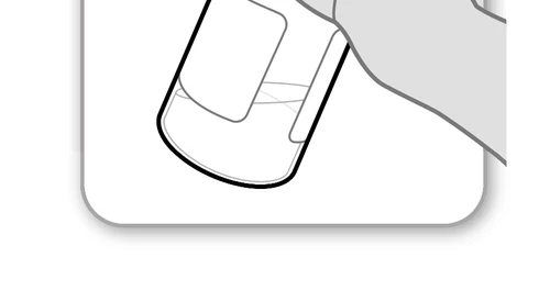One hand holding a medicine vial tilted to facilitate the