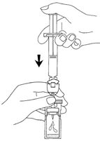 One hand holding a syringe vertically while the