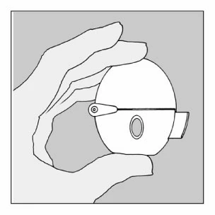 A hand holds a spherical medical device with a small central viewing window and a protruding lateral element against a gray background