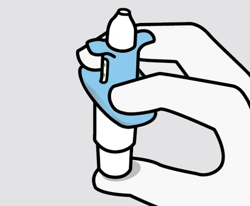 A white hand holding a blue and white medical device for