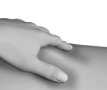 A human hand resting on a smooth, curved surface representing a body part such as a leg or hip