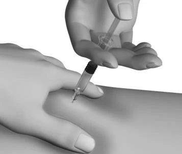 A hand holds a syringe with a thin needle and inserts it vertically into the skin of a person's arm supported by the