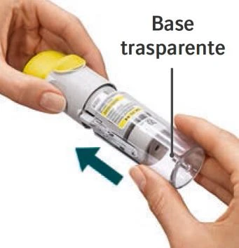 Two hands holding a cylindrical medical device with a transparent base indicated by a black line and a green arrow pointing to the left