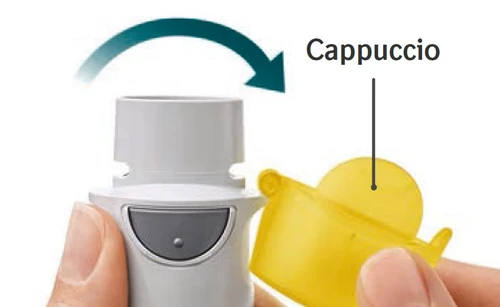 Hands removing a yellow cap from a grey cylindrical medical device with a green curved arrow indicating rotational movement