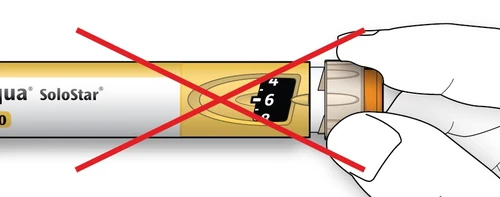 A hand attempting to remove the transparent cap from a SoloStar injection pen with a large red cross over it