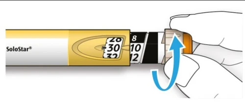 A hand rotating the end part of a SoloStar injection pen to adjust the dose, displaying numbers on the graduated scale