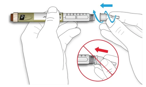 Two hands gripping an injection pen to rotate the end part to the left, indicated by blue arrows and a red prohibition sign