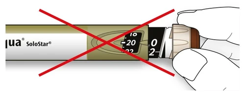 Detail of a SoloStar pen with a large red X over it indicating it should not be used
