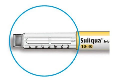 Detail of a Suliqua Solo 10-40 injection pen with a visible millimeter scale on the transparent body of the device