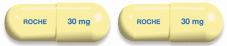 Two identical yellow capsules with the word ROCHE in blue on one side and the dosage 30 mg on the other