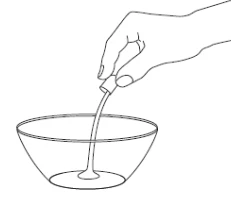 A hand holding a small container and pouring a liquid into it