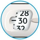 Close-up of a graduated scale with black numbers 28, 30, and 32 on a white background at the