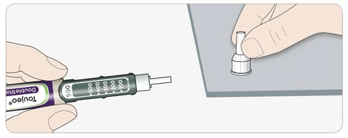 A hand holding a Toujeo injection pen with graduated scale while the