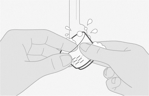 Two hands holding and opening a small container or vial containing liquid
